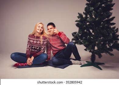 Winter, Fashion, Couple, Christmas And People Concept - Smiling Man And Woman On Background