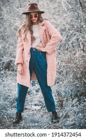 Winter Fashion. Full Length Portrait Of A Beautiful Young Woman In Trendy  Clothes Posing Next To The Reeds On The Background Of The Winter Landscape.