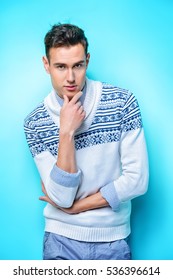 Winter Fashion. Handsome Young Man In Woolen Sweater Posing At Studio. 