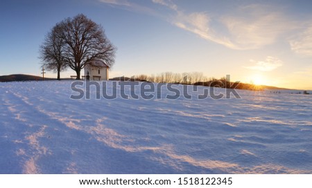 Winter field witn chapel - panorama rural landscape
