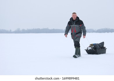 Winter Fishing. Fisherman In Winter On The Ice Of The Lake. Fishing Gear.