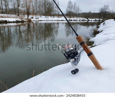winter fishing in a wild river. tackle for fishing. moment while fishing.