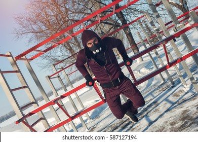 Winter Fitness. Young Male Adult In High Altitude Training Mask Working Out.