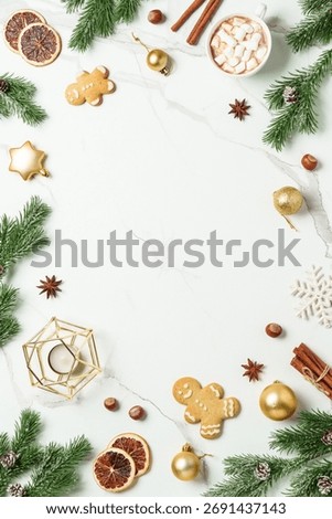 Winter flat lay creative layout at white. Gingerbread cookies with hot chocolate, spices and christmas decorations.