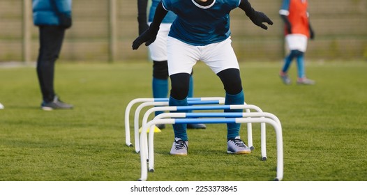 Winter Football Soccer Training Camp. Player in Soccer Winter Clothes on Training with Hurdles. Athlete Player Practice Hurdle Jump - Shutterstock ID 2253373845