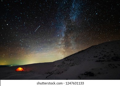Winter frost night in the high mountains of the Ukrainian Carpathians, with overnight stay in a red tent under the glow of the Milky Way - Shutterstock ID 1247631133