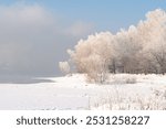 Winter frosty evaporation from the river in cold weather. Winter city landscape in Siberia