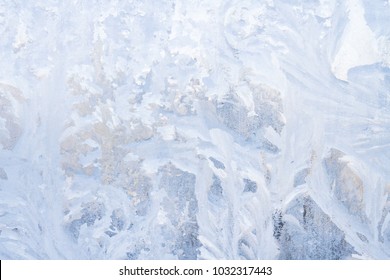 Winter frosty patterns on the frozen ice window - Shutterstock ID 1032317443