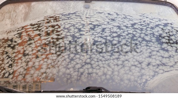 Winter frozen front window car, ice glass\
freeze texture\
background\
