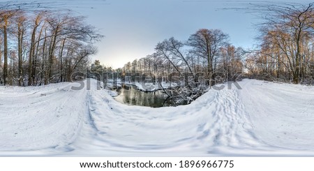 Winter full spherical seamless hdri panorama 360 degrees angle view on road in a snowy park near small river in equirectangular projection. 
