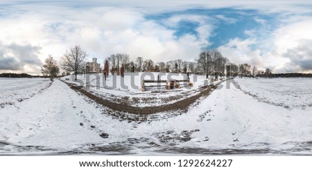 Winter full spherical seamless panorama 360 degrees angle view on road in a snowy park with blue sky near frozen city lake in equirectangular projection. VR AR content
