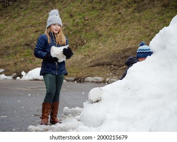 Winter Fun. Cheerful Child In A Hat Plays Snowballs 2020