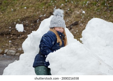 Winter Fun. Cheerful Child In A Hat Plays Snowballs 2020