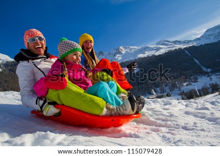 Winter fun, snow, family sledding at winter time