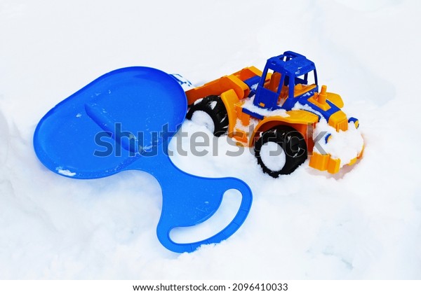Winter Games. Children\'s winter toys close-up on\
white snow.