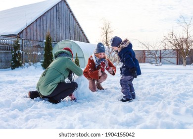 Winter Games With Snow.Happy Family Playing In The Yard Of The House In Social Distance, Lockdown.Digital Detox, Slowdown, Real Moments, Slow Life,staycation