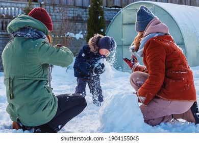 Winter Games With Snow.Happy Family Playing In The Yard Of The House In Social Distance, Lockdown.Digital Detox, Slowdown, Real Moments, Slow Life,staycation