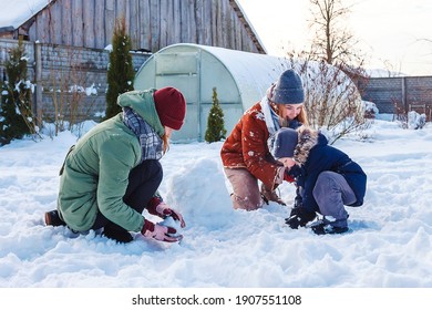 Winter Games With Snow.Happy Family Playing In The Yard Of The House In Social Distance, Lockdown.Digital Detox, Slowdown, Real Moments, Slow Life,staycation