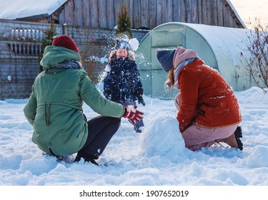 Winter Games With Snow.Happy Family Playing In The Yard Of The House In Social Distance, Lockdown.Digital Detox, Slowdown, Real Moments, Slow Life,staycation