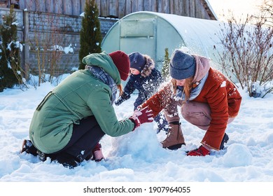 Winter Games With Snow.Happy Family Playing In The Yard Of The House In Social Distance, Lockdown.Digital Detox, Slowdown, Real Moments, Slow Life,staycation