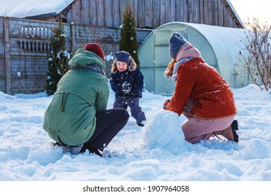 Winter Games With Snow.Happy Family Playing In The Yard Of The House In Social Distance, Lockdown.Digital Detox, Slowdown, Real Moments, Slow Life,staycation