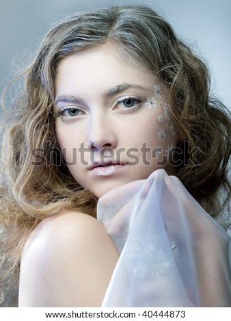 winter girl with beautiful make up on blue background