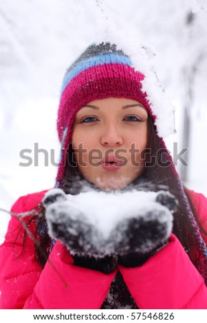 winter girl blow on snow