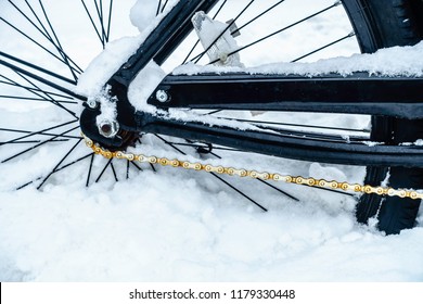 Winter at a glance: Closeup of rear wheel and rusting chain of bicycle stuck in snow, for themes of weather, transportation, adversity - Shutterstock ID 1179330448