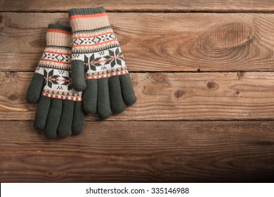 Winter Gloves On Wooden Background