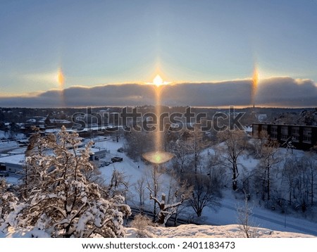 Winter Halo over town. Top view horizon. Rainbow halo arround the sun. 