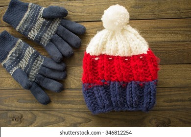 Winter Hat And Gloves On Wooden Background