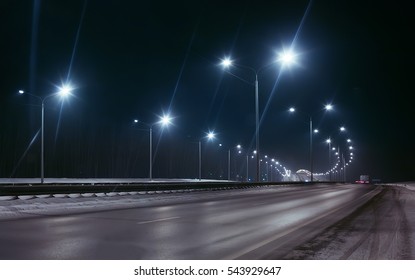 winter highway at night shined with lamps