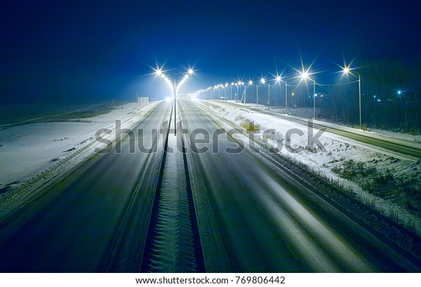 winter highway at
night shined with lamps