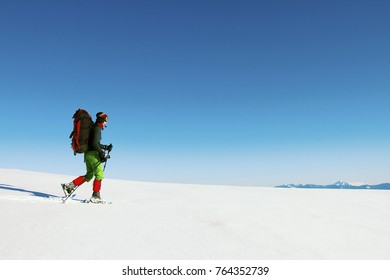 Winter hike in the mountains with a backpack and tent. - Shutterstock ID 764352739