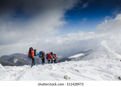 Winter hiking. Active people exploring snowy mountains - Powered by Shutterstock