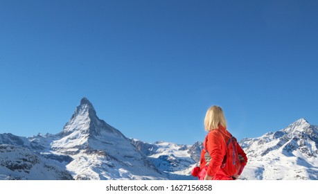 Winter Hiking In Zermatt, Switzerland. Blond Woman Outside.