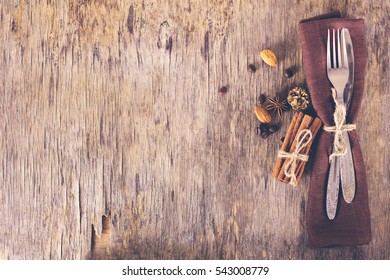 Winter holiday dinner plate decoration on old wood background. table set with a winter, Christmas decoration. Winter holiday theme. Happy New Year. Space for text.