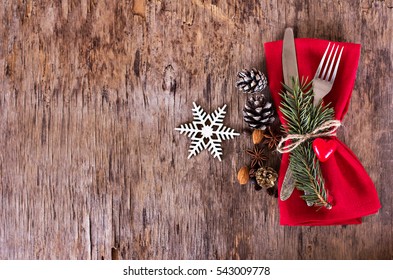 Winter holiday dinner plate decoration on old wood background. table set with a winter, Christmas decoration. Winter holiday theme. Happy New Year. Space for text.