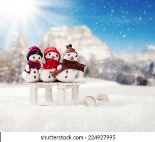 Winter holiday happy snow men with blur landscape on background. Concept love and togetherness
