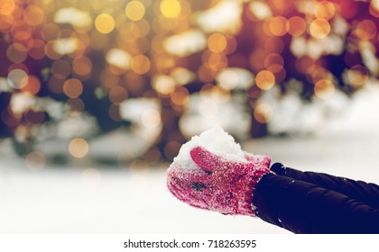 winter holidays, christmas and people concept - close up of woman holding snow outdoors