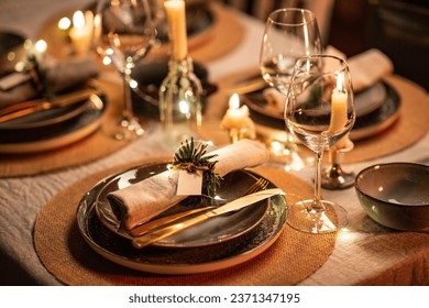 winter holidays, dinner party and celebration concept - close up of scandinavian christmas table serving with burning candles at home at night - Powered by Shutterstock