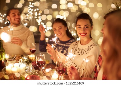 Winter Holidays And People Concept - Happy Friends With Sparklers Celebrating Christmas At Home Feast