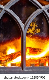 Winter At Home. Closeup Of Fireplace With Orange Fire Flame Interior. Heating.