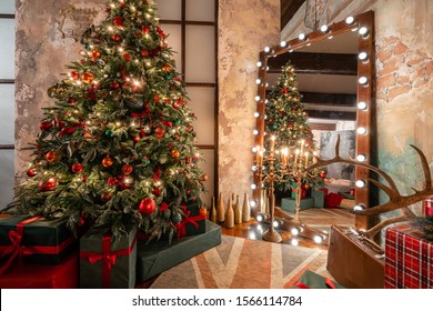 Winter home decor. Christmas in loft interior against brick wall. gifts under the tree. star lamp with light bulbs. Mirror garlands