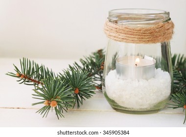 Winter Home Relaxing Time. Pretty Homemade Candle Holder - Tea Light In Jar With Salt And Green Pine Boughs. Rustic Style Table Decor 