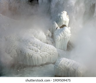 In Winter, Ice And Frost Build Up In From The Mist Created By Niagara Falls.  Beautiful Ice Formations Occur On The Rocks At The Base Of The Falls.  Seagulls Fly Through The Mist.