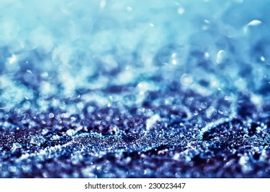 Winter iced glowing blue pattern with bokeh, holiday seasonal background