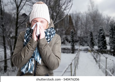 Winter Illness Concept With Woman Blowing Into Napkin Outside In The Snowy Day With Copy Text Space