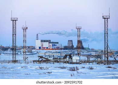Winter industrial landscape. A view of the towers and structures of a gas-pumping station in the tundra and a large combined heat and power plant. Industry and Energy in the Arctic. Chukotka, Russia. - Shutterstock ID 2092591702