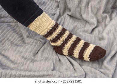 Winter knitted sock on a woman's foot- education, magazines and marketing - Powered by Shutterstock